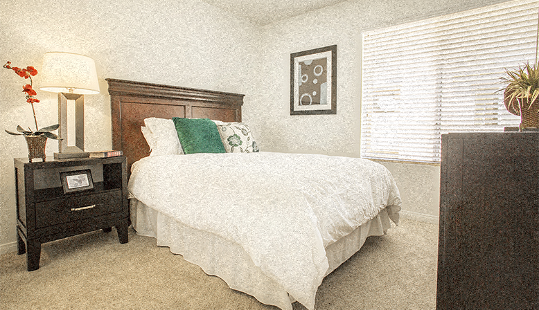 a bedroom with a bed and a dresser and a window