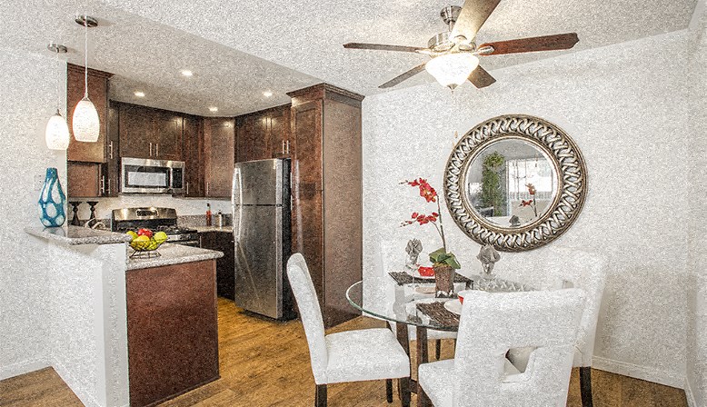 a kitchen and dining room with a table and chairs