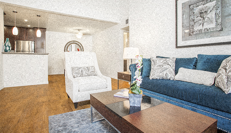 a living room with a blue couch and a coffee table