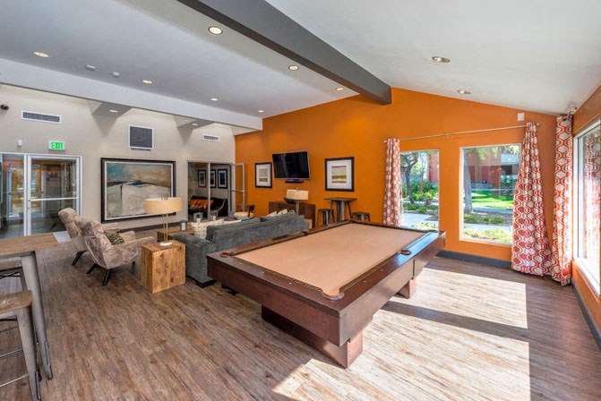 a large living room with a pool table