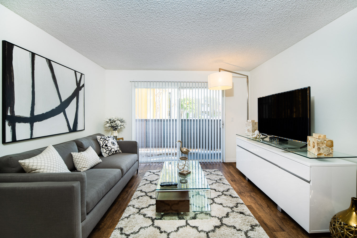 a living room with a couch and a glass coffee table