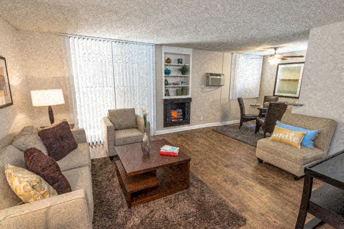 a living room with couches and chairs and a fireplace