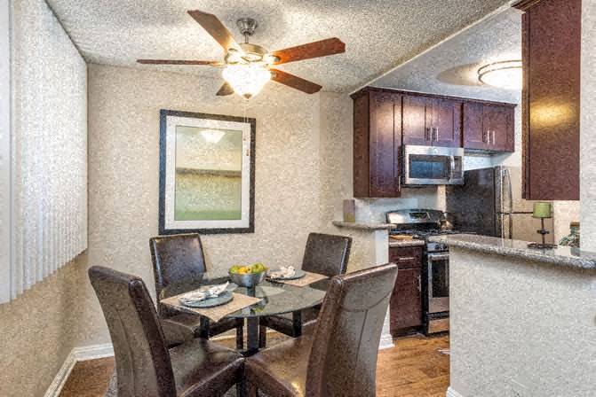a kitchen and dining room with a table and chairs