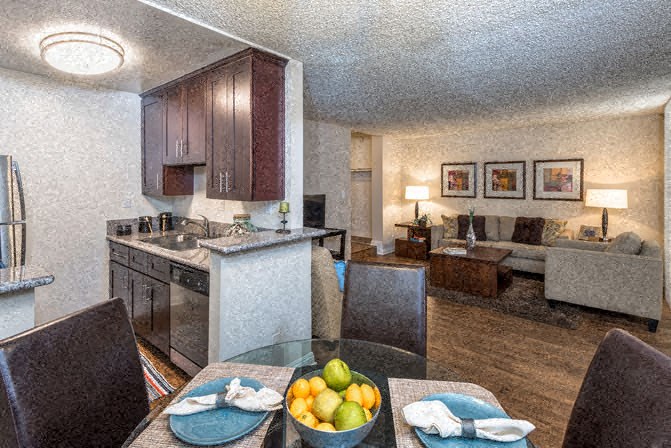 a living room with a kitchen and a dining table