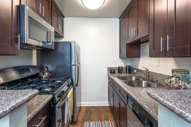 a kitchen with a stove sink and refrigerator