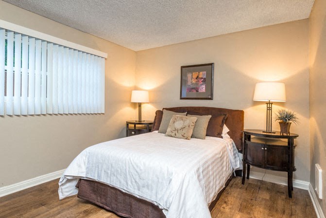 a bedroom with a bed and two lamps