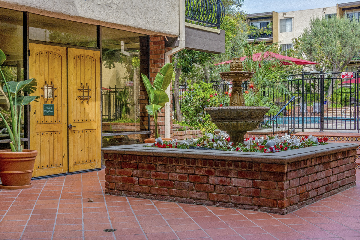 a fountain in a courtyard in front of a building