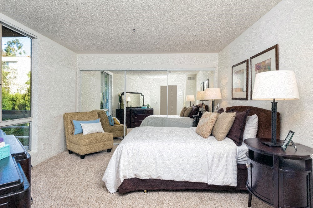 a bedroom with a large bed and a window