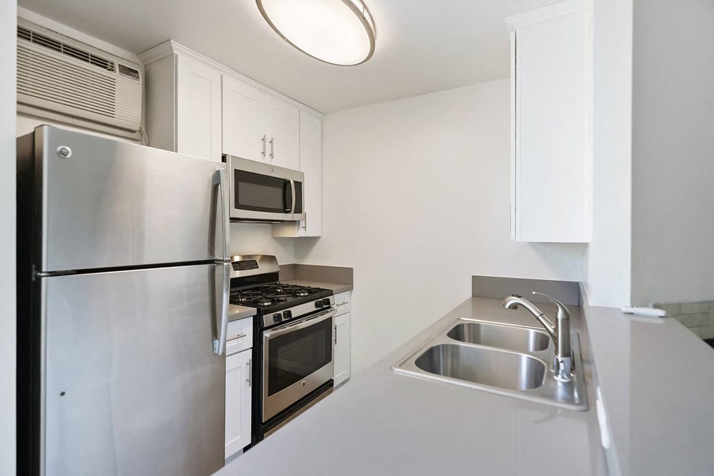 a kitchen with stainless steel appliances and a sink