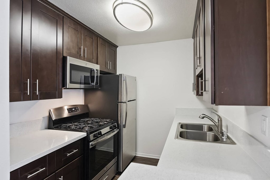 a kitchen with a sink and a refrigerator