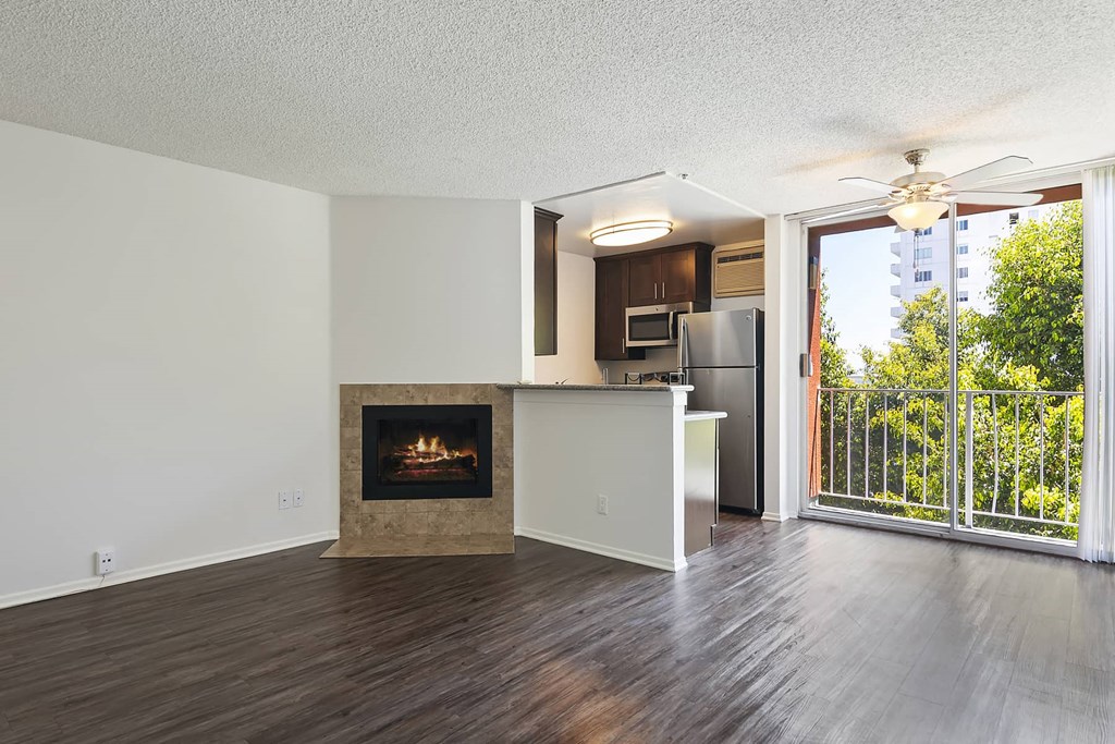 a living room with a fireplace and a balcony