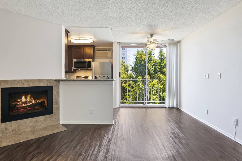 an empty living room with a fireplace and a window