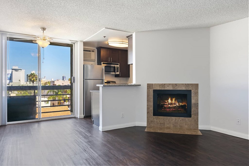 a living room with a fireplace and a balcony