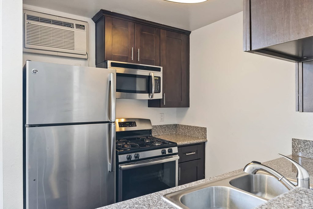 a kitchen with stainless steel appliances and a refrigerator