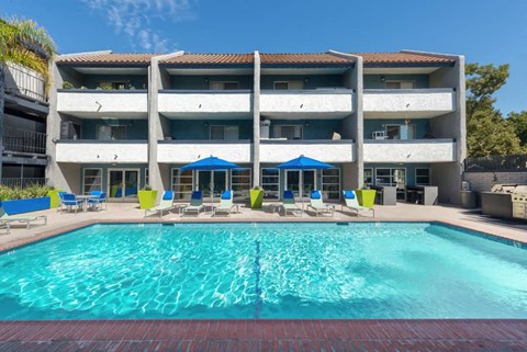 a large swimming pool in front of a hotel