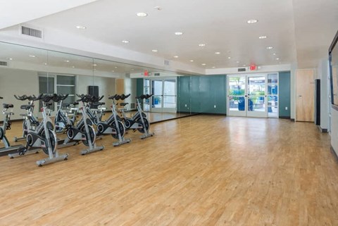 a fitness room with exercise bikes in it