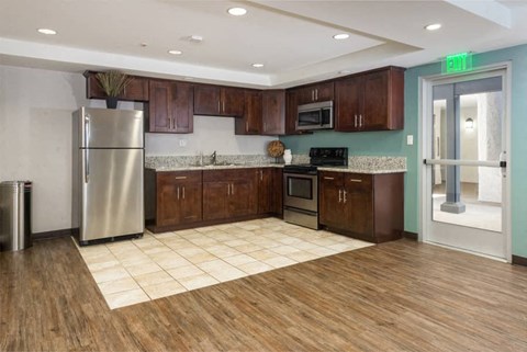 a large kitchen with a stainless steel refrigerator