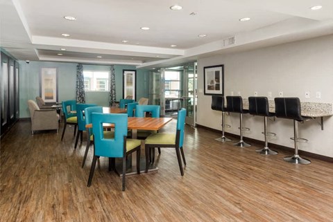 a dining room with tables and chairs and a bar