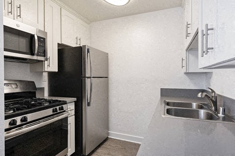 a kitchen with a sink and a refrigerator