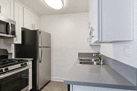 a kitchen with a sink and a refrigerator