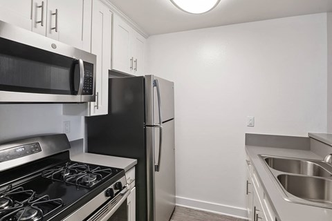 a kitchen with a stove microwave and refrigerator