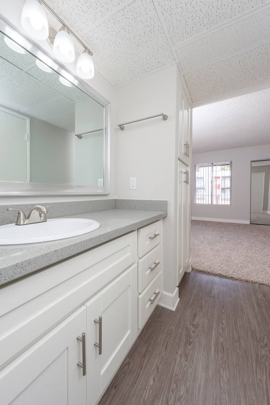 a white bathroom with a sink and a mirror