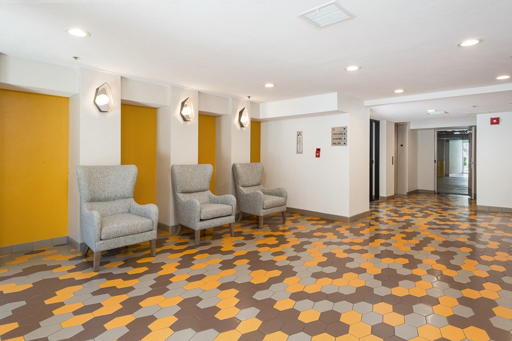 a room with four chairs and a yellow and white floor