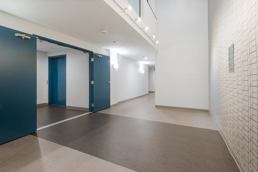 a large room with white walls and blue doors