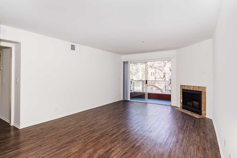 a living room with a fireplace and wooden floors