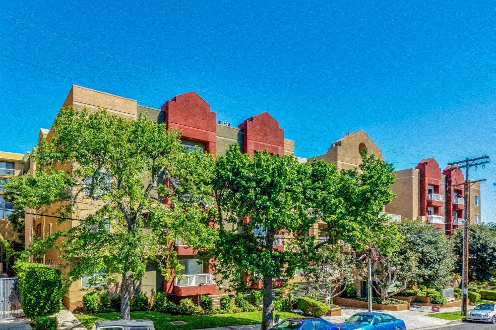 a group of buildings with trees in front of them