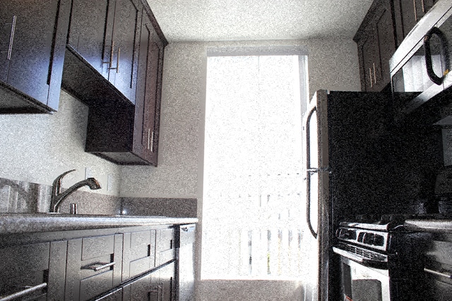 A kitchen with a sink, stove, and refrigerator.