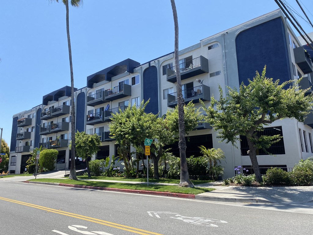 a large apartment building with trees in front of it