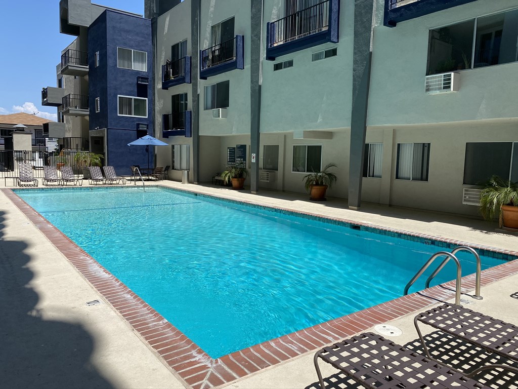 a swimming pool in front of an apartment building