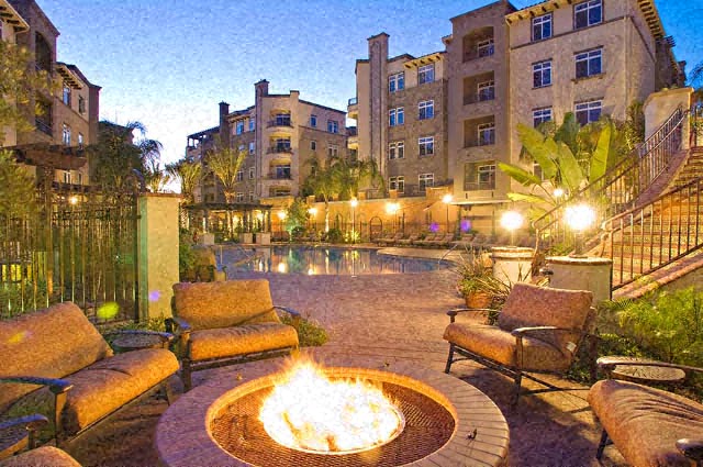 a backyard with a fire pit and a swimming pool