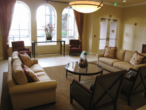 a living room with couches and chairs and a table