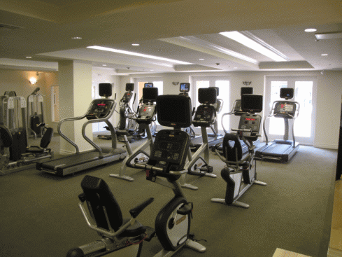 the gym has a lot of equipment in it