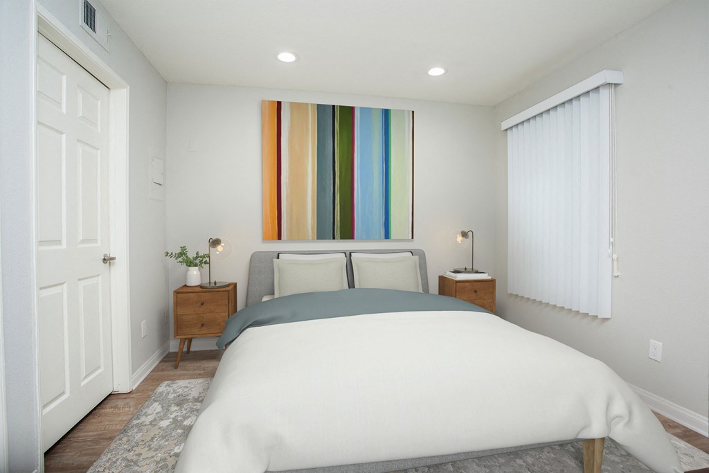 a bedroom with a bed and a painting on the wall