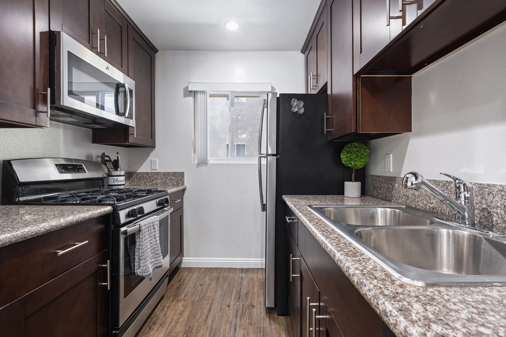 the kitchen of a home with granite counter tops and stainless steel appliances