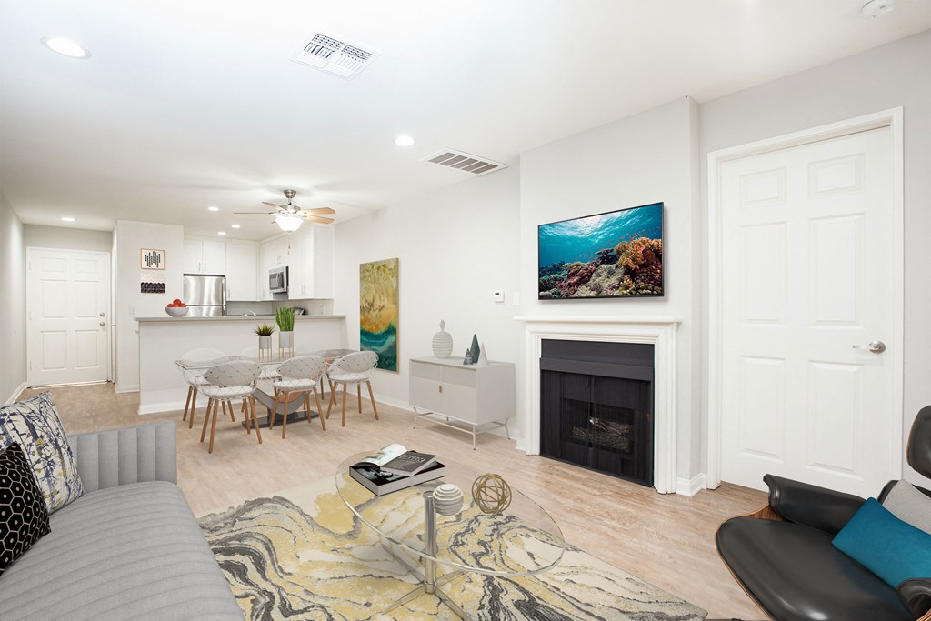 a living room with a fireplace and a table with chairs