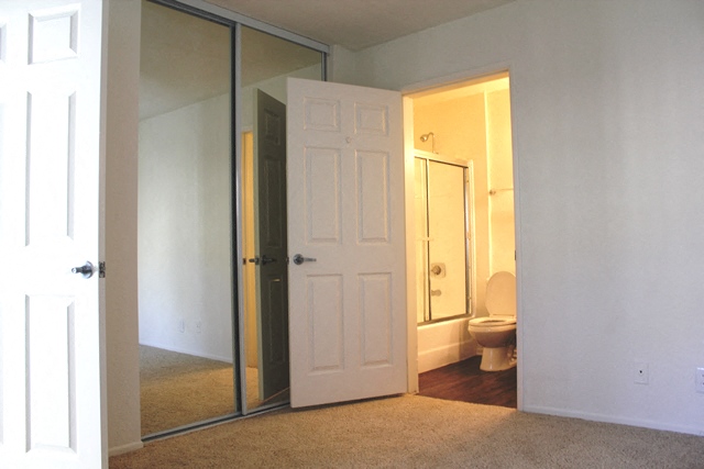 a bathroom with a white door and a toilet