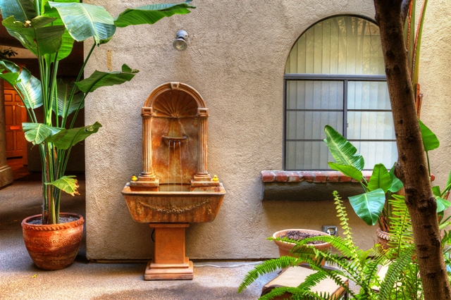 a fountain in front of a building with a window