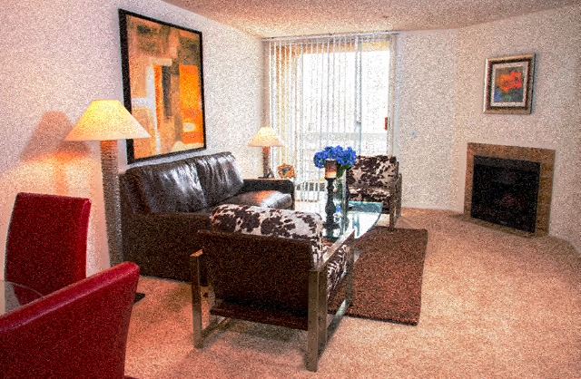 a living room with leather furniture and a fireplace