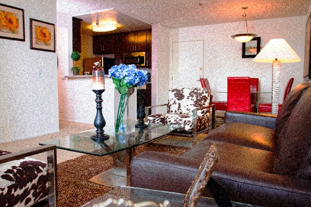 a living room with couches and a glass table