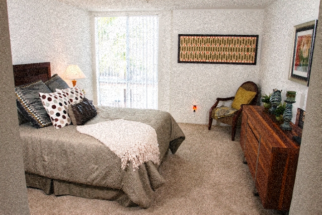 a bedroom with a bed and a dresser