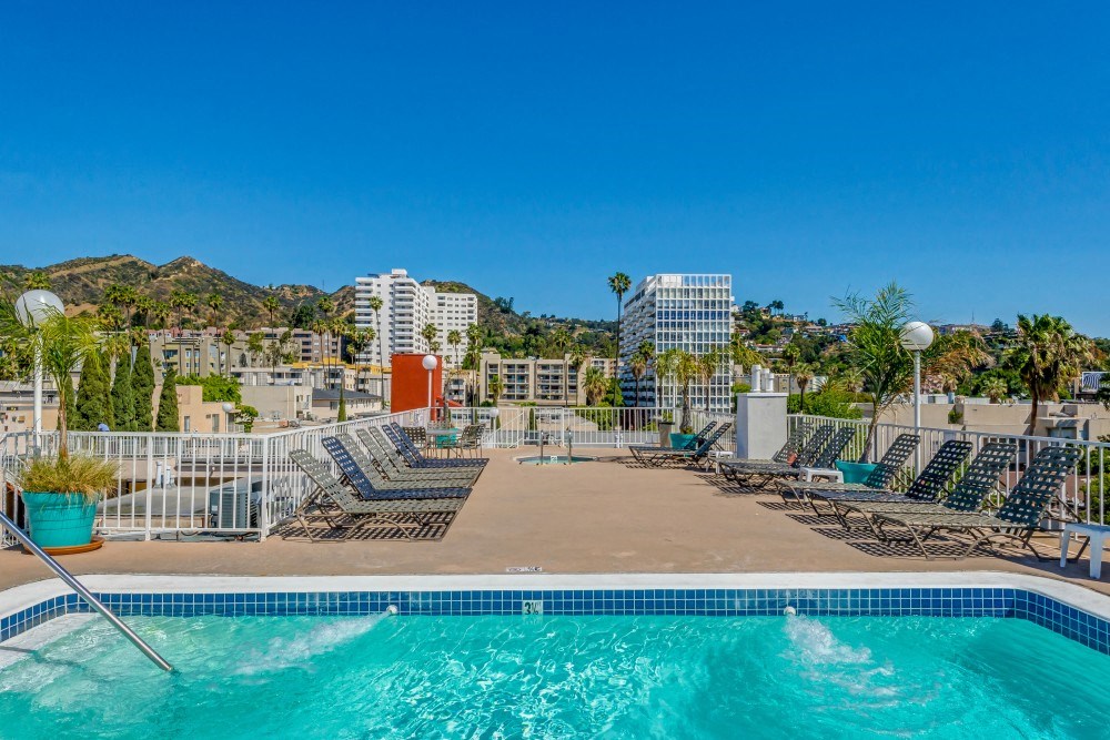 a swimming pool at a resort with a city in the background