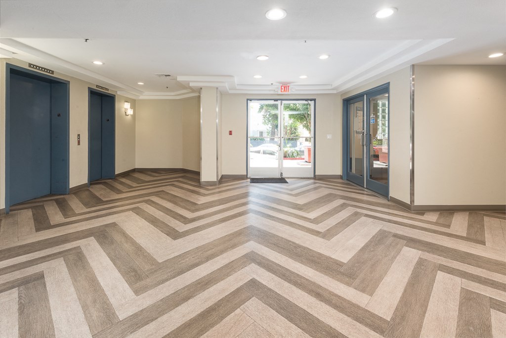 a lobby with a checkered floor and doors
