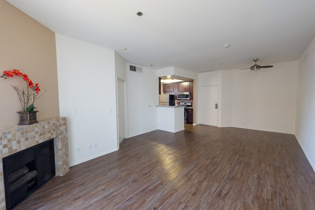 a living room with a fireplace and a hard wood floor