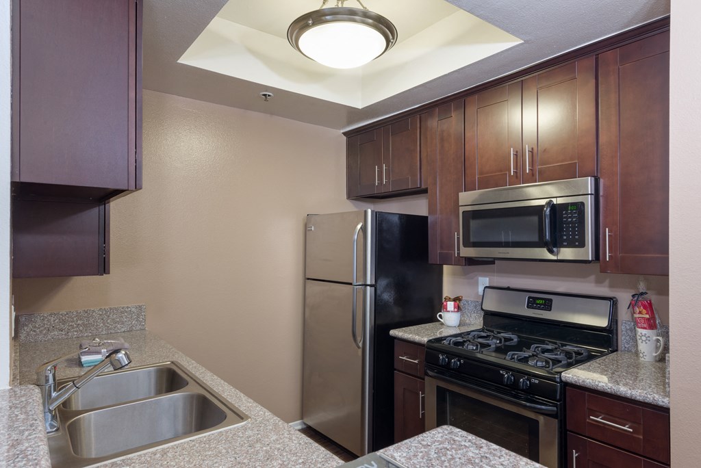 a kitchen with stainless steel appliances and granite counter tops