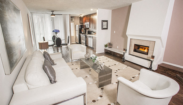 a living room with a white couch and a fireplace