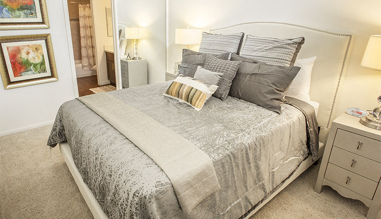 a bedroom with a bed and pillows on it